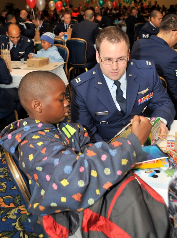 VANDENBERG AIR FORCE BASE, Calif. -- As children arrived at the Pacific Coast Club here to celebrate Operation Kids Christmas, they were all given a backpack with several school supplies and coloring books. Capt. Christian Gabriel, who works with 392nd Training Squadron, and Keyna Purrett ,from Los Angeles, Calif., go through the backpack while waiting for the event to start.  (U.S. Air Force photo/Senior Airman Stephanie Longoria)









