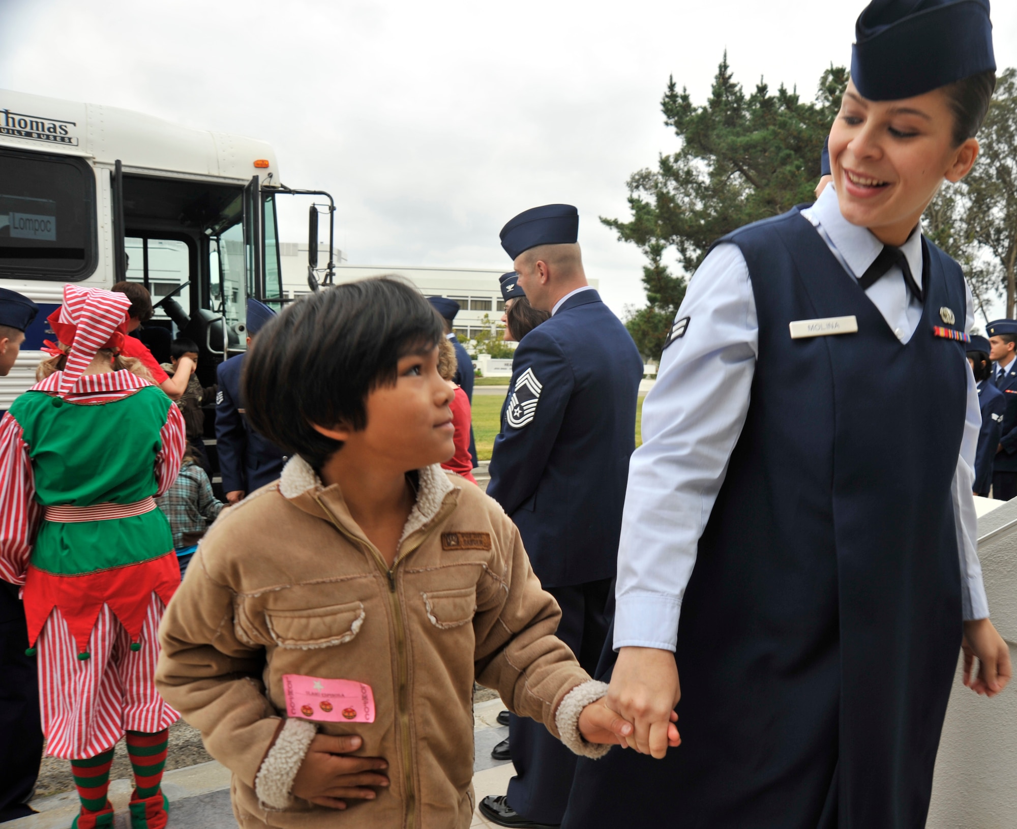 VANDENBERG AIR FORCE BASE, Calif. --  Airman 1st Class Kerelin Molina, from the 30th Space Wing, quickly bonds with Olaho Espinosa, from Lompoc, Calif., due to her knowledge of the Spanish language during Operation Kids Christmas here Saturday, Dec. 5, 2009. Event coordinators made sure that bilingual escorts were available to help Spanish speaking children.    (U.S. Air Force photo/Senior Airman Stephanie Longoria)




