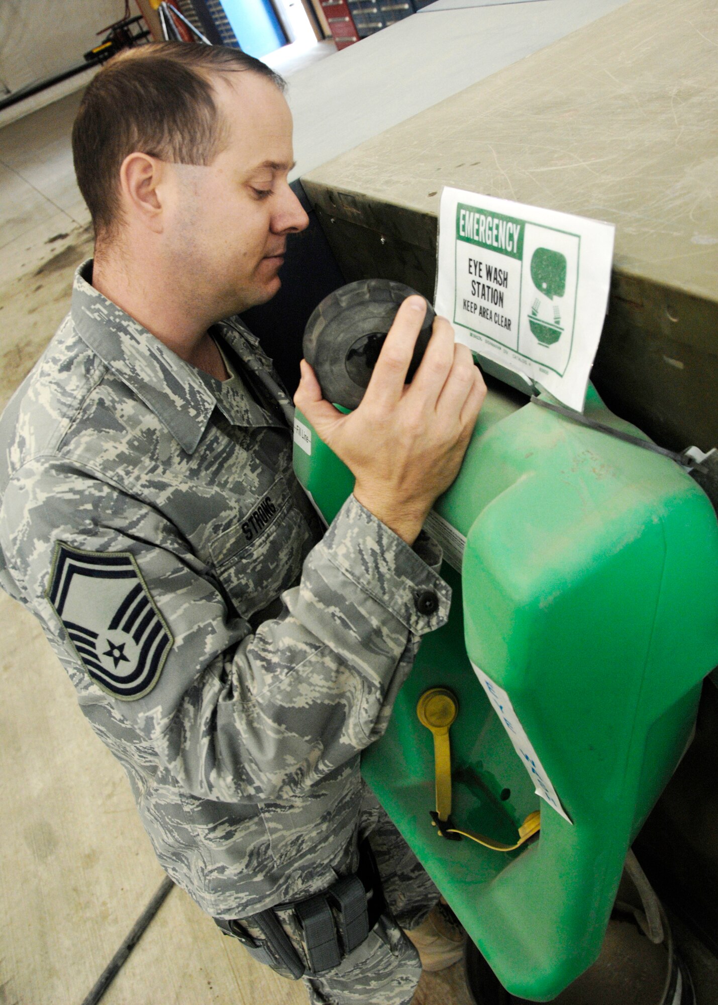 Senior Master Sgt. Bruce Strong Jr. inspects an eyewash station to ensure all standards are being met Dec. 5, 2009, at Kandahar Airfield, Afghanistan. Sergeant Strong is a ground safety manager for the Air National Guard in Maryland. (U.S. Air Force photo/Senior Airman Timothy Taylor)