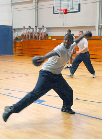 Senior Airman Jamal Avington helps the 437th Force Support Squadron to a second place win in the dodgeball tournament during the Commander's Fitness Challenge at the Fitness and Sports Center here Dec. 4. The 16th Airlift Squadron won the first two games in a three game series defeating the 437 FSS. Airman Avington is assigned to the 437 FSS. (U.S. Air Force photo/ Airman 1st Class Lauren Laidlaw)