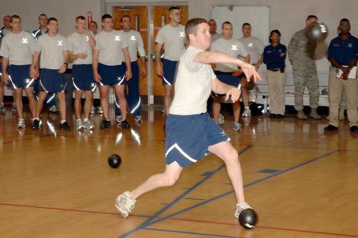Josh Whitacare throws the ball in an intense game of dodgeball during the Commander's Fitness Challenge at the Fitness and Sports Center here Dec. 4. More than 200 people showed up to participate and support their fellow squadron members. Whitacare is assigned to the 16th Airlift Squadron. (U.S. Air Force photo/Staff Sgt. Marie Brown)