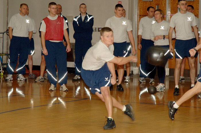 Kelby Hagerla throws the ball during the Commander's Fitness Challenge at the Fitness and Sports Center here Dec. 4. The 16th Airlift Squadron won the first two games in a three game series defeating the 437th Force Support Squadron in the championship game. Hagerla is assigned to the 16 AS. (U.S. Air Force photo/Staff Sgt. Marie Brown)