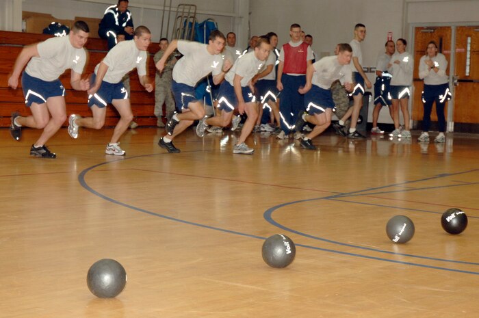 Airmen from the 16th Airlift Squadron race to the center line in an intense game of dodgeball during the Commander's Fitness Challenge at the Fitness and Sports Center here Dec. 4. The 16th Airlift Squadron went on to defeat the 437th Force Support Squadron in the championship game. (U.S. Air Force photo/Staff Sgt. Marie Brown)
