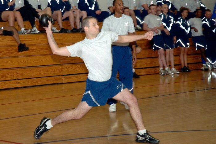 Riley Cusson prepares to throw the ball during an intense game of dodgeball at the Commander's Fitness Challenge hosted by the 437th Maintenance Group at the Fitness and Sports Center here Dec. 4. More than 200 people showed up to participate and support their fellow squadron members. Cusson is assigned to the 437th Communications Squadron. (U.S. Air Force photo/Staff Sgt. Marie Brown)