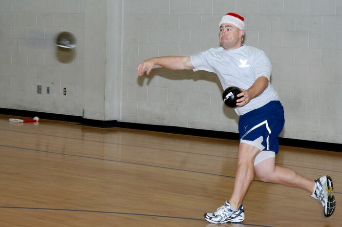 Timothy Huffman throws a ball in an intense game of dodgeball during the Commander's Fitness Challenge at the Fitness and Sports Center here Dec. 4. The 16th Airlift Squadron won the first two games in a three game series defeating the 437th Force Support Squadron in the championship game. Huffman is assigned to the 437th Operations Support Squadron. (U.S. Air Force photo/Staff Sgt. Marie Brown)