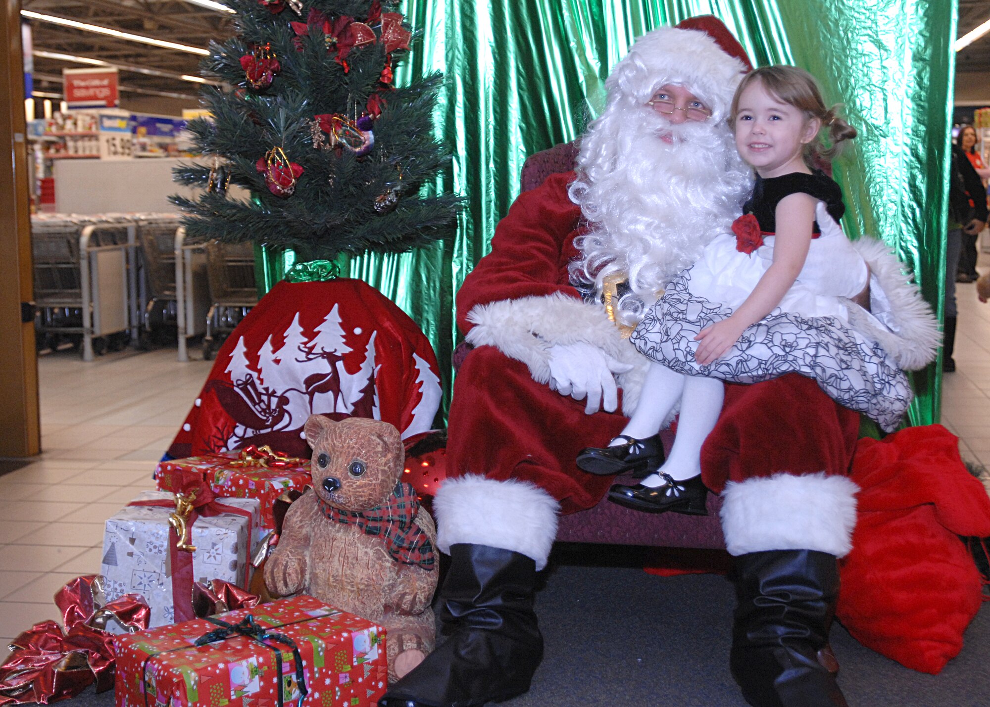 AVIANO AIR BASE, Italy --  Faith Philips tells Santa her wish list at the Aviano Base Exchange Dec. 3, 2009 at Aviano Air Base, Italy. Santa arrived at the BX following the Tree Lighting ceremony to visit with base children and listen to their holiday wishes.  (U.S. Air Force photo/Airman 1st Class Tabitha Mans)