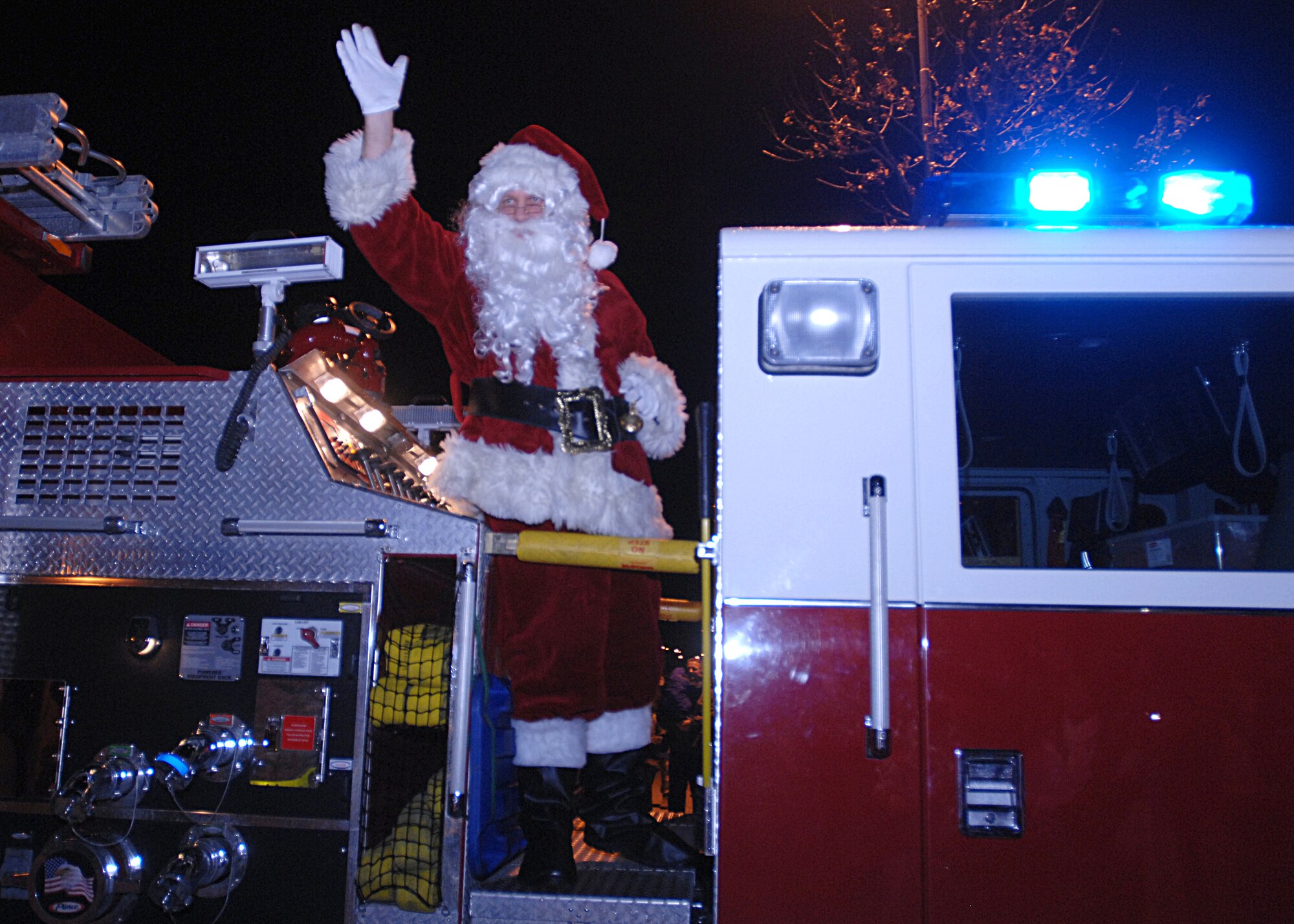 AVIANO AIR BASE, Italy --  Santa Claus rides a fire engine to the Aviano Base Exchange Dec. 3, 2009  at Aviano Air Base, Italy.  Santa arrived after the Tree Lighting ceremony to visit with base children.  (U.S. Air Force photo/Airman 1st Class Tabitha Mans)