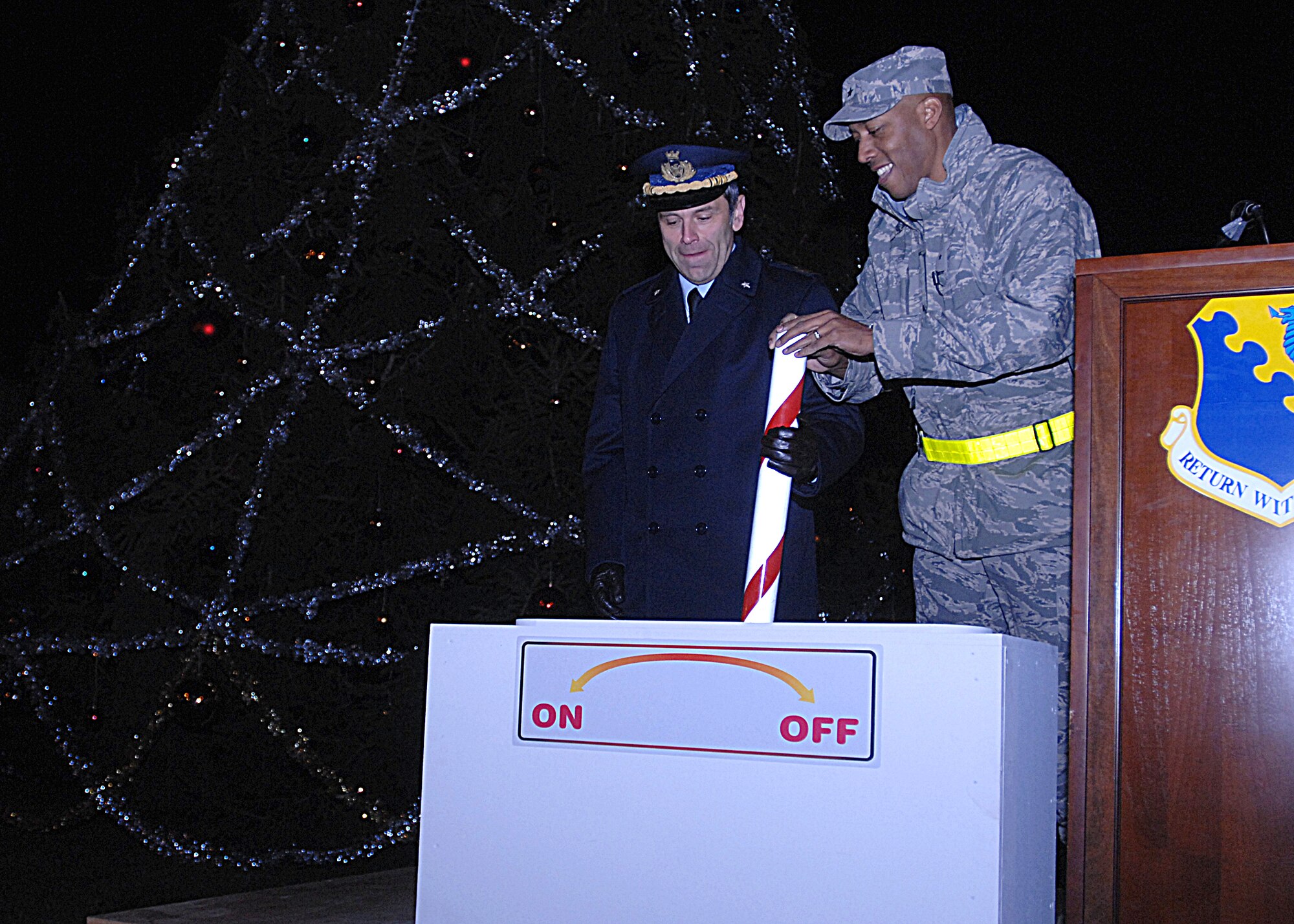 AVIANO AIR BASE, Italy --  Col. Filippo  Zampella , Italian Air Force "Pagliano e Gori" Airport commander, and Brig. Gen. C.Q. Brown, Jr., 31st Fighter Wing commander, light the holiday tree Dec. 3, 2009 at Aviano Air Base, Italy.  The Holiday Tree Lighting gave the Aviano and Italian community a chance to share holiday cheer.  (U.S. Air Force photo/Airman 1st Class Tabitha Mans)