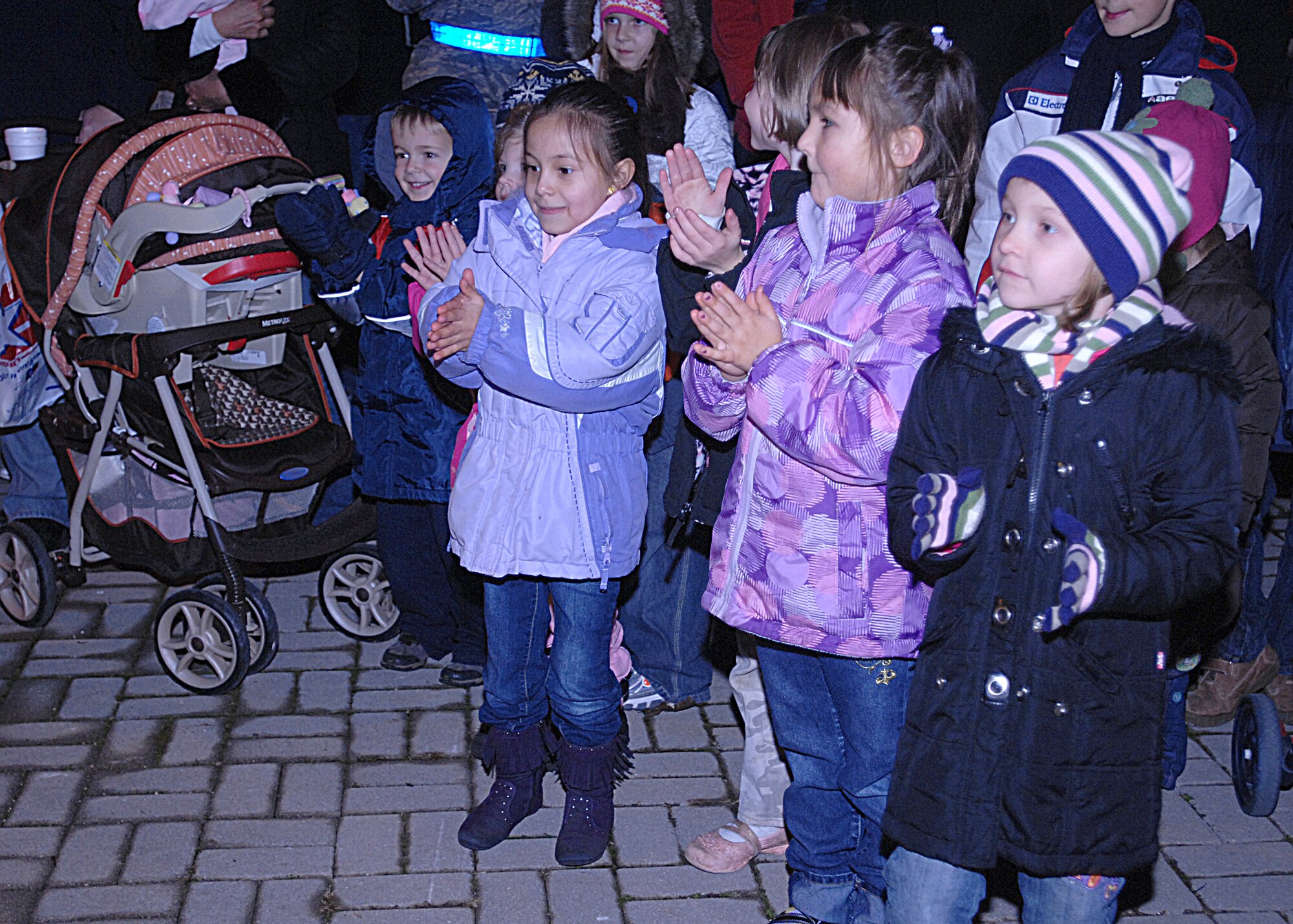 AVIANO AIR BASE, Italy --  Children dance to the music of the Zampognari band during the Holiday Tree Lighting ceremony, Dec. 3, 2009 at Aviano Air Base, Italy.  Base children enjoyed music, hot chocolate, cookies and visits from Santa and friends.  (U.S. Air Force photo/Airman 1st Class Tabitha Mans)