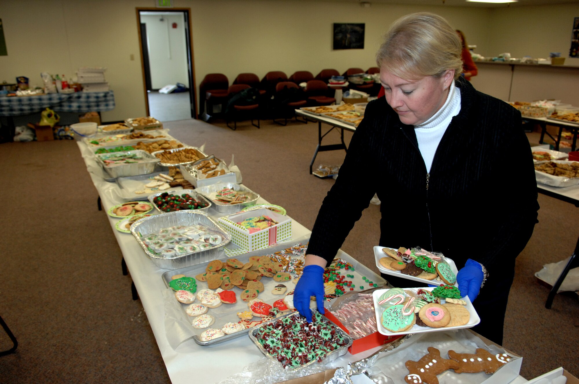 MINOT AIR FORCE BASE, N.D. -- Lynae Cox, wife of Col. Douglas Cox, 5th Bomb Wing commander, prepares plates of holiday cookies to be delivered to 1,100 Airmen living in the dormitories here Dec. 3. The holiday cookie drive for Minot Airmen is a yearly event engineered to reach out to young Airmen who live in the dorms. (U.S. Air Force photo by Senior Airman Michael Veloz)