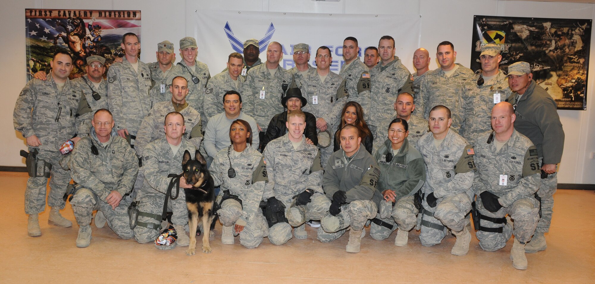 Tech. Sgts. Christian Craig and Robert Young, 512th Security Forces Squadron Airmen currently assigned to the 506th Expeditionary SFS, are pictured with Singer Kid Rock (center wearing black), Comedian Carlos Mencia (center left), and Singer Jessie James (center right), following a Dec. 4 concert at Kirkuk Regional Air Base, Iraq. The two Dover reservists helped provide security at Kirkuk RAB during the Tour for the Troops 2009 show , formerly known as Operation Season's Greetings. Sergeant Craig is on the first row furthest right, and Sergeant Young is on the back row, sixth in from the left. 
