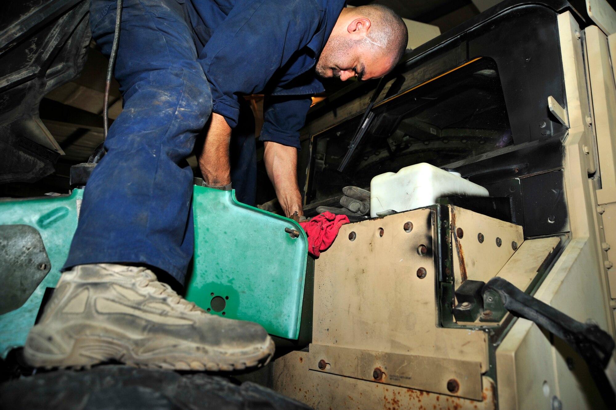 SOUTHWEST ASIA - Staff Sgt. Oscar Feliciano, 380th Expeditionary Logistics Readiness Squadron, removes an alternator so it can be replaced on a HMMVW (High-mobility multipurpose wheeled vehicle) Dec. 8, 2009. Sergeant Feliciano is deployed from the 217th Electronics Installation Squadron in Springfield, Ill., and calls Chicago, Ill., home. (U.S. Air Force photo/Senior Airman Stephen Linch)

 
