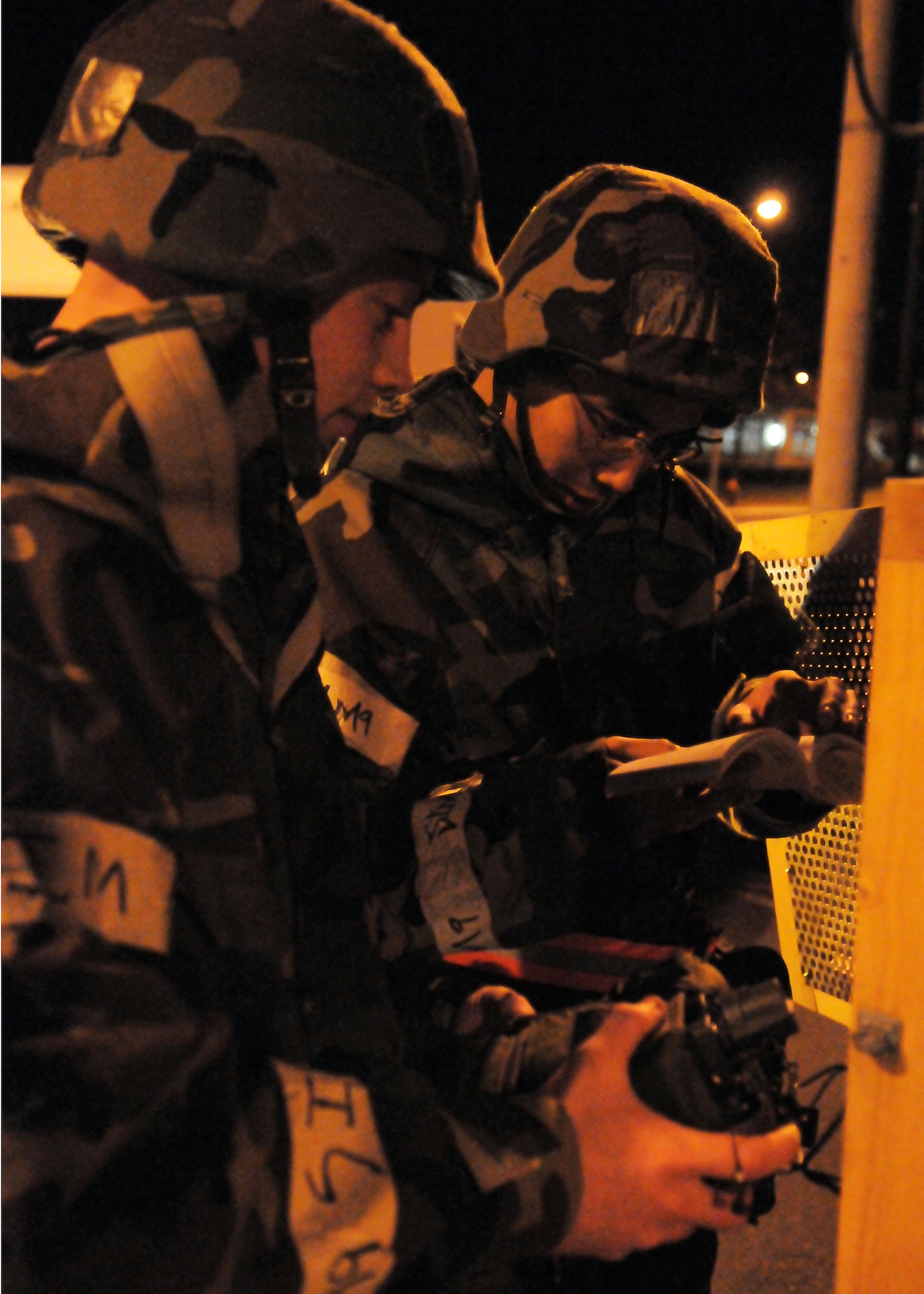 YOKOTA AIR BASE, Japan -- Senior Airman Alexander Mayhall, 374th Communications Squadron, (left) and Airman 1st Class Perry Neang, 374th Civil Engineer Squadron, replace batteries in a joint chemical agent detector during an operational readiness inspection conducted by the Pacific Air Forces Inspector General. (U.S. Air Force photo/Airman 1st Class Michael Dillon)