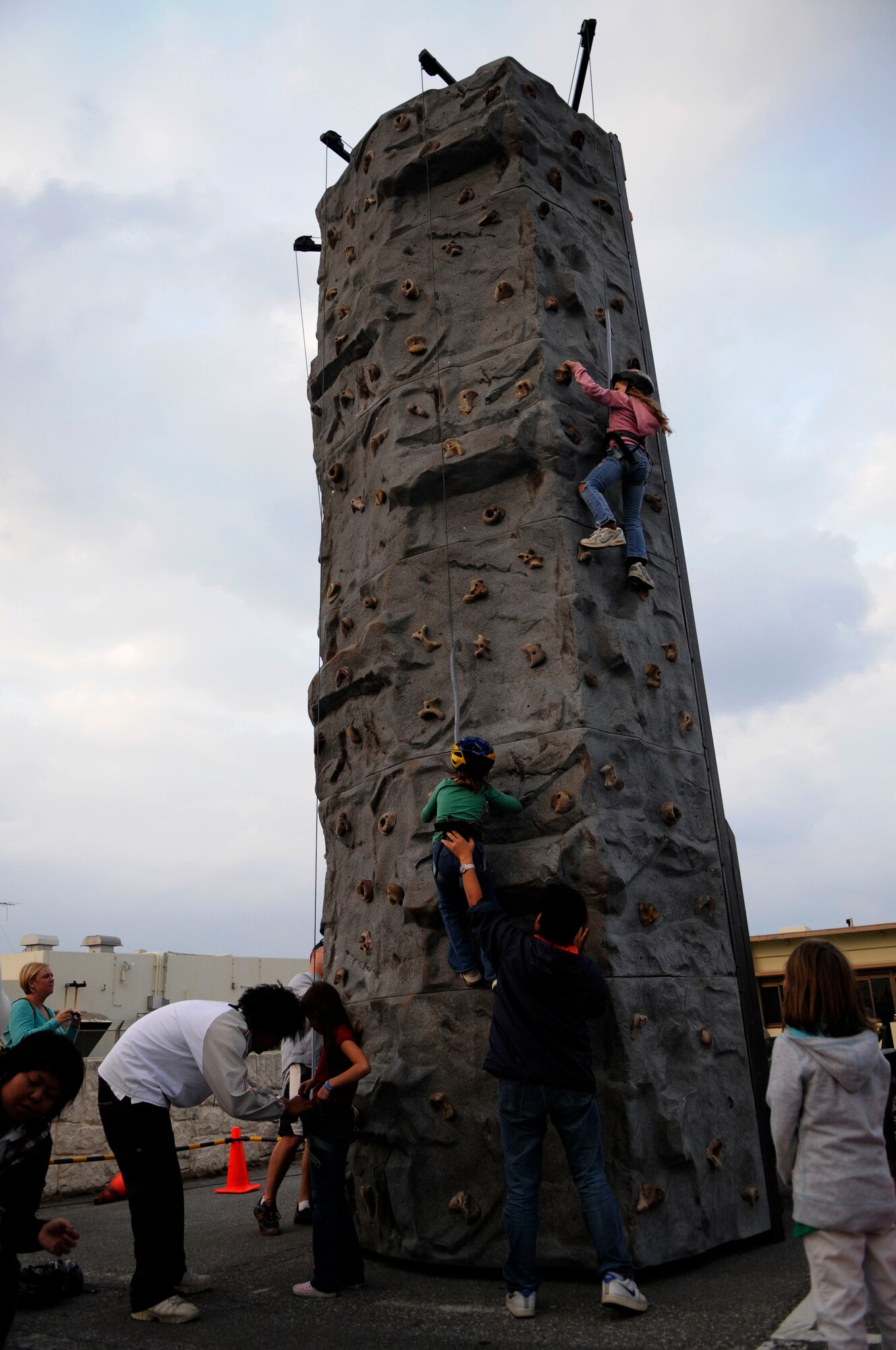 Children climb a rock wall at Tinsel Town, a holiday festival sponsored by the 18th Force Support Squadron and held at Kadena’s Schilling Community Center Dec. 5-6. Those in attendance were entertained by a holiday parade, live music, games, carnival rides and food. The first evening was culminated by a Christmas tree lighting ceremony. 
(U.S. Air Force photo/Staff Sgt. Christopher Hummel)