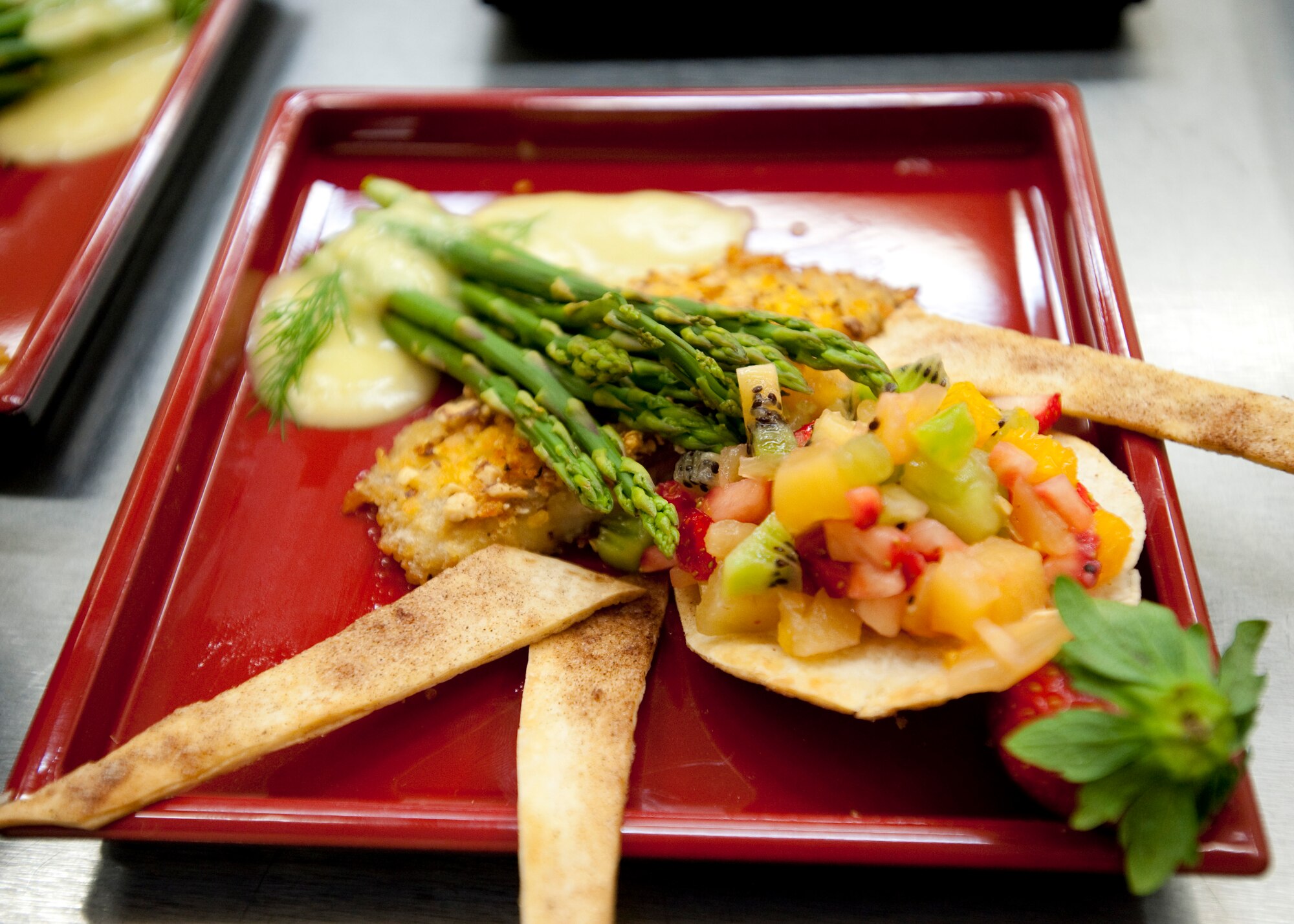 MISAWA AIR BASE, Japan -- The main course from the A-Team sits ready to be served during the Iron Chef Competition at Grissom Dining Facility Dec. 4. The A-Team prepared Mike's Italian Dish, fruit salsa with cinnamon chips and smoked almond-encrusted tilapia as their main course. (U.S. Air Force photo/Staff Sgt. Samuel Morse)