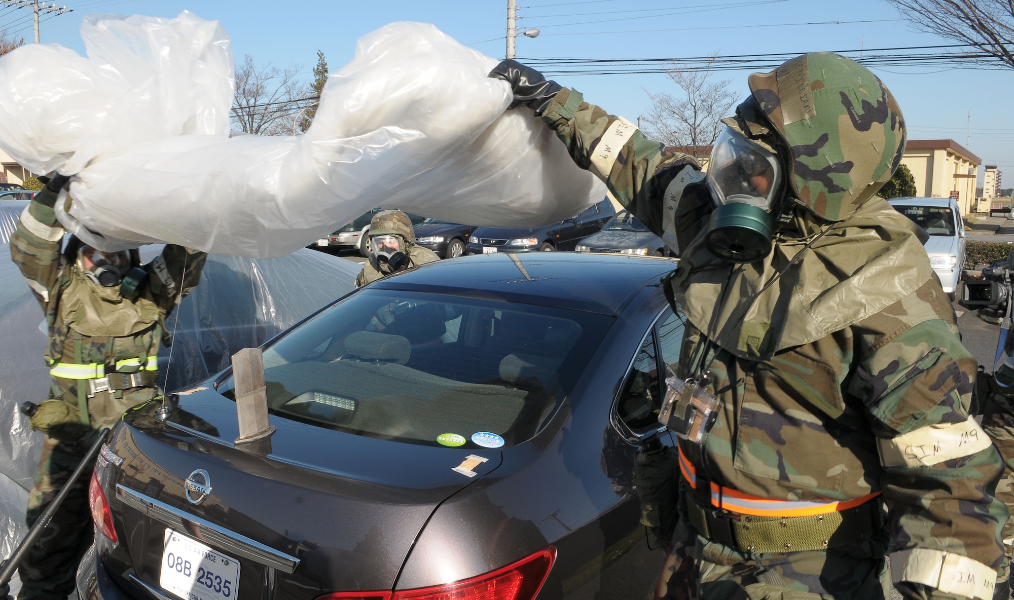 YOKOTA AIR BASE, Japan -- Members of a post attack reconnaissance team uncover a contaminated vehicle Dec. 8 during an operational readiness inspection conducted by the Pacific Air Forces Inspector General. PAR teams are responsible for checking for contamination, damage, casualties and unexploded ordnance following attacks on the base. (U.S. Air Force photo/Airman 1st Class Sean Martin)