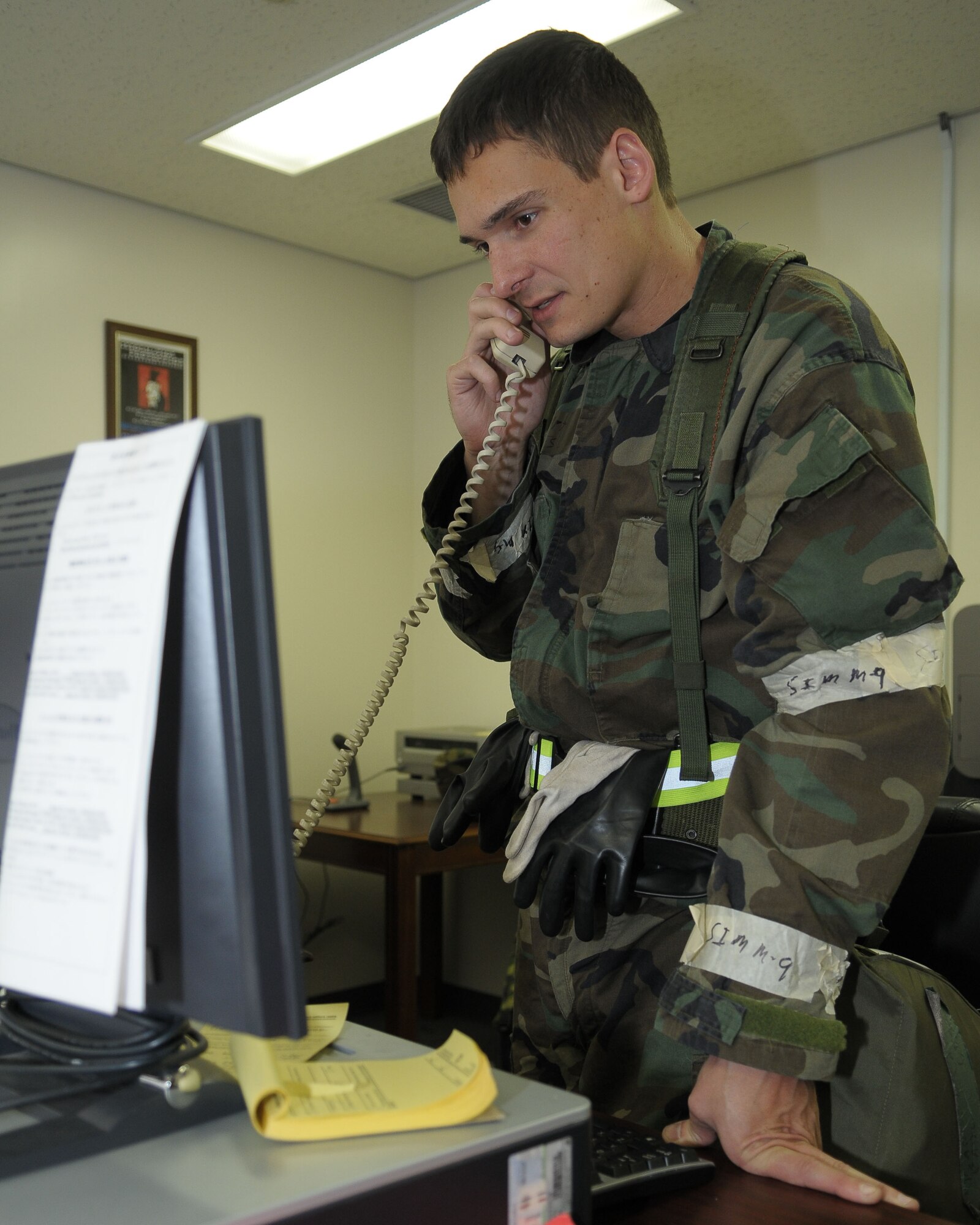 YOKOTA AIR BASE, Japan -- Capt. Paul Gesl, 374th Airlift Wing, relays accountability information in a group control center Dec. 8 during an operational readiness inspection conducted by the Pacific Air Forces Inspector General. The GCCs manage accountability of personnel and resources and alert Airmen to changes in the force protection condition and mission oriented protective posture. (U.S. Air Force photo/Airman 1st Class Sean Martin)