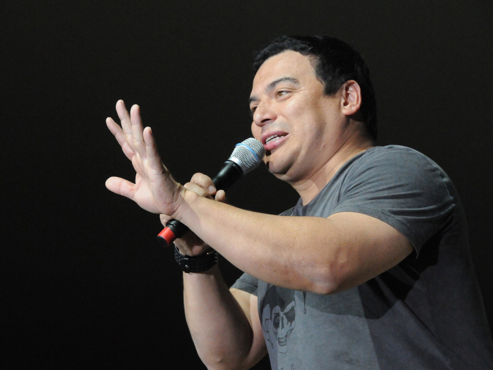Carlos Mencia performs for a live audience of deployed servicemembers in Southwest Asia, Dec. 6, 2009. Tour for Troops 2009 will visit various deployed locations throughout Southwest Asia and Europe and is sponsored by the U.S. Air Force Reserve Command. (U.S. Air Force Photo/Tech Sgt. Jason W. Edwards)