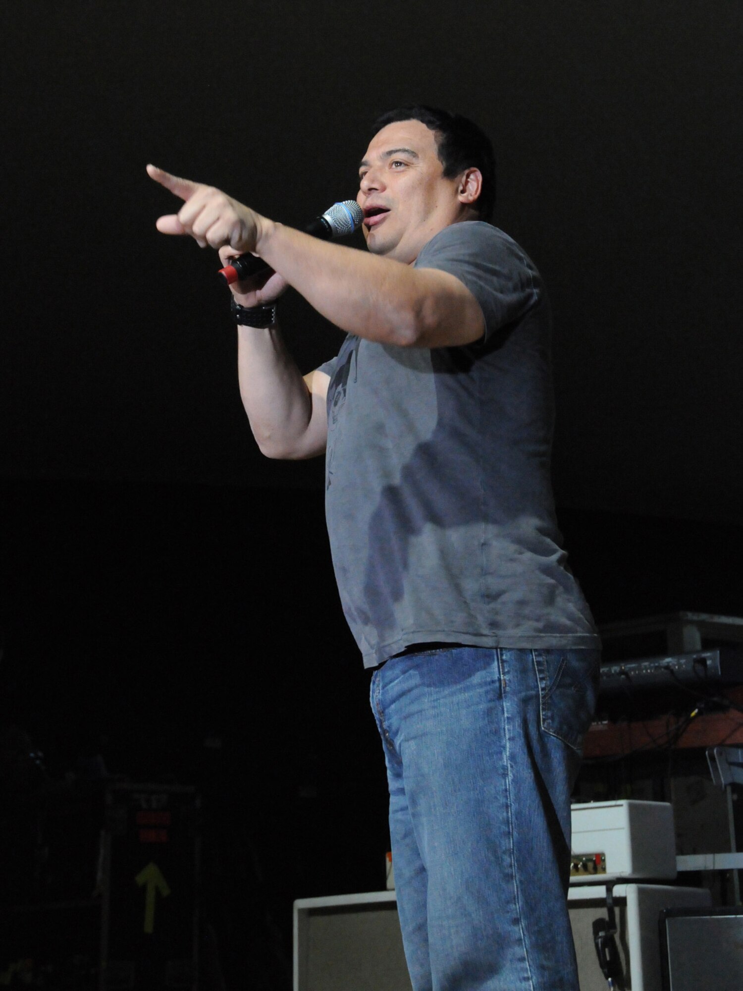 Carlos Mencia performs for a live audience of deployed servicemembers in Southwest Asia, Dec. 6, 2009. Tour for Troops 2009 will visit various deployed locations throughout Southwest Asia and Europe and is sponsored by the U.S. Air Force Reserve Command. (U.S. Air Force Photo/Tech Sgt. Jason W. Edwards)