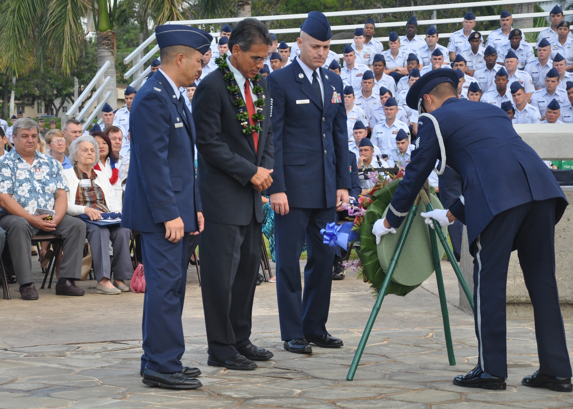 HICKAM AIR FORCE BASE, Hawaii -- Col. Giovanni Tuck, 15th Airlift Wing commander, Hawaii Lieutenant Governor James ?Duke? Aiona, Jr., and Chief Master Sgt. Craig Recker, 15th AW command chief master sergeant, lay a wreath at Atterbury Circle to pay tribute to the U.S. servicemembers who gave their lives during the Dec. 7, 1941 attacks on Hickam Field. Survivors and their families from the infamous day were on hand to pay tribute to their lost brothers and sisters in arms. Wreaths and tokens of honor were laid at the base of the memorial at Atterbury Circle. (U.S. Air Force photo/Staff Sgt. Mike Meares)