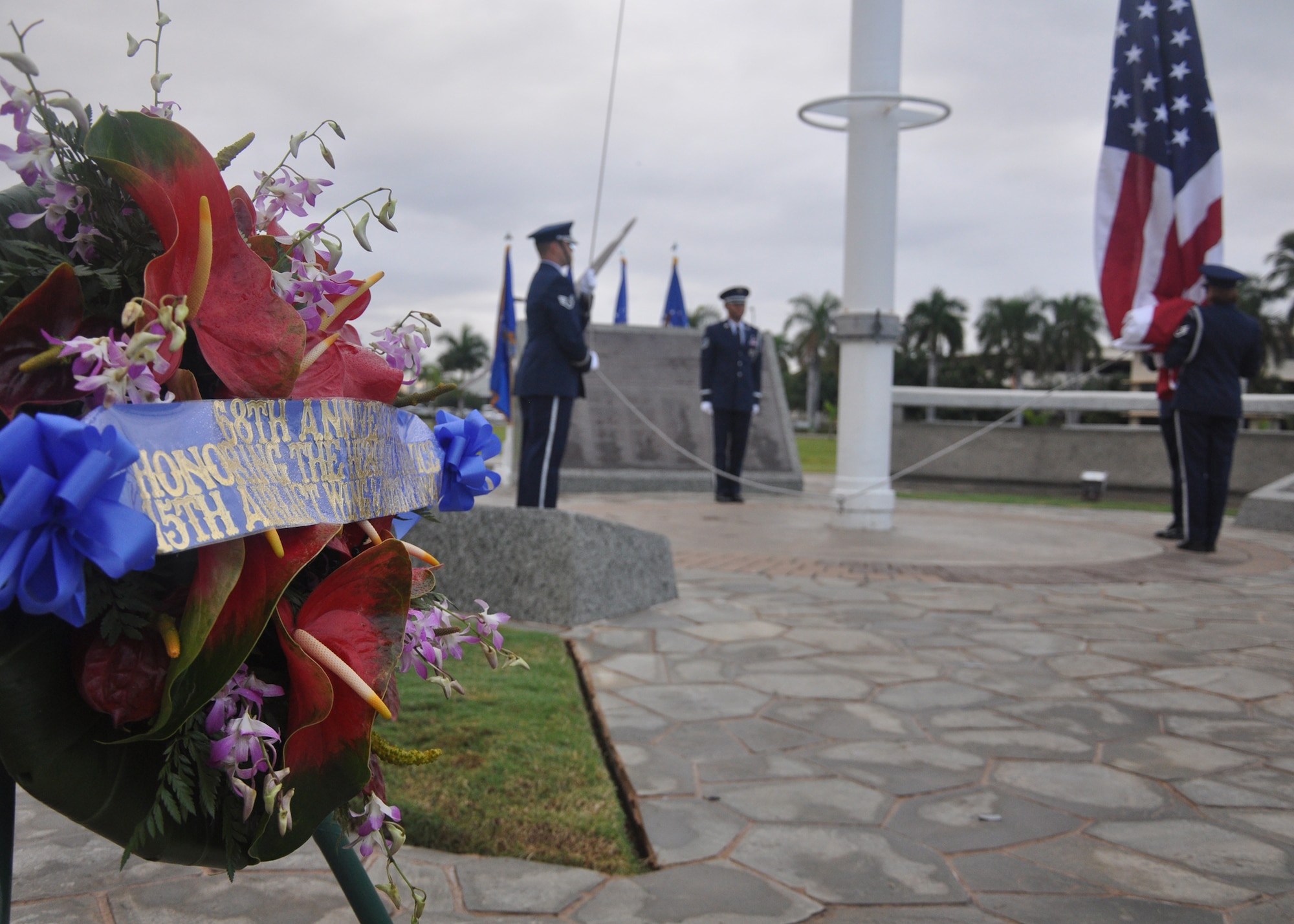 HICKAM AIR FORCE BASE, Hawaii -- The Hickam Honor Guard prepares to raise the U.S. flag during the ceremony that marked the anniversary of the Dec. 7, 1941, attacks on Pearl Harbor Navy Fleet and the Army Air Corps fields of Hickam, Wheeler and Bellows. Survivors and their families from the infamous day were on hand to pay tribute to their lost brothers and sisters in arms. Wreaths and tokens of honor were laid at the base of the memorial at Atterbury Circle. (U.S. Air Force photo/Staff Sgt. Mike Meares)
