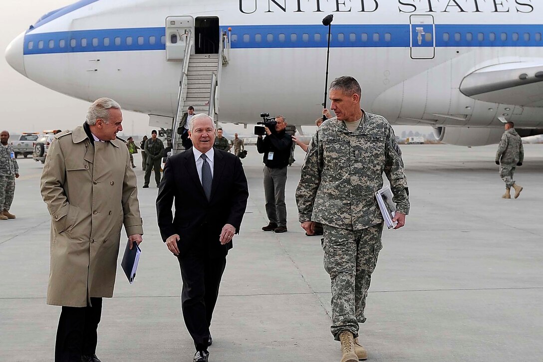U.S. Defense Secretary Robert M. Gates, center, walks with Francis J. Ricciardone Jr., deputy U.S. ambassador to Afghanistan,  left, and U.S. Army Gen. David Rodriguez, deputy commander of the NATO International Security Assistance Force, right, after arriving in Kabul, Dec. 8, 2009. 