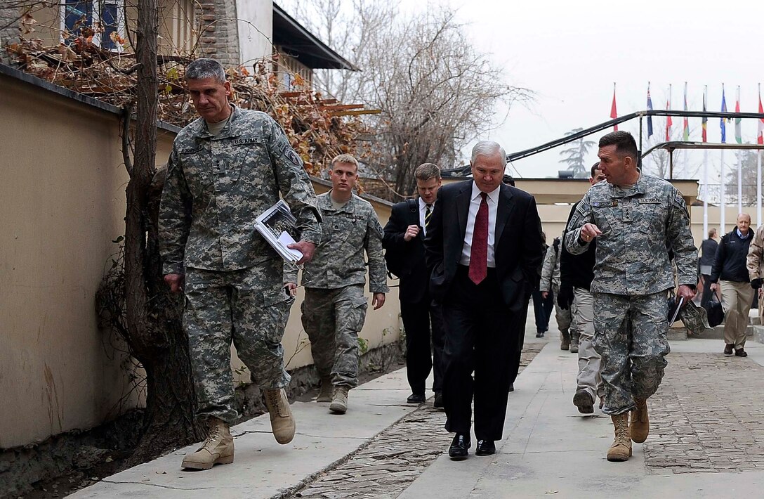 U.S. Defense Secretary Robert M. Gates, center, walks with U.S. Army Gen. David Rodriguez,  deputy commander of the NATO International Security Assistance Force,  left, and U.S. Army Lt. Gen. William Caldwell IV, NATO Training Mission commander, right, while on Camp Eggers in Kabul, Dec. 8, 2009. 