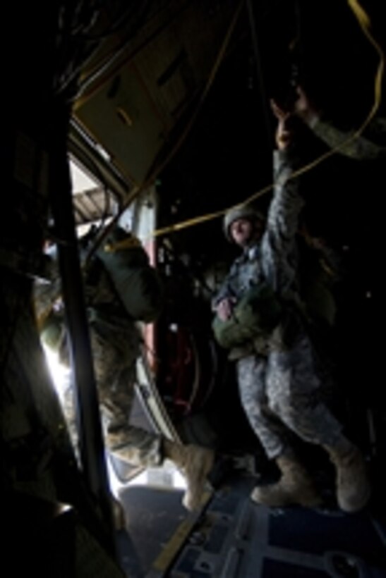 U.S. Army soldiers from Fort Bragg, N.C., jump out of a U.S. Air Force C-130 Hercules aircraft from the 910th Airlift Wing, Youngstown, Ohio, during the 12th annual Randy Oler Memorial Toy Drop at Fort Bragg, N.C., on Dec. 6, 2009.  Also known as Operation Toy Drop, the event is hosted by the U.S. Army Civil Affairs and Psychological Operations Command (Airborne) and supported by Fort Bragg's XVIII Airborne Corps and Pope Air Force Base's 43rd Airlift Wing.  Organizers estimate that more than 3,000 soldiers will donate a toy for a lottery ticket and the chance to jump under an international jumpmaster in order to earn their foreign jump wings.  The operation gives soldiers and airmen the opportunity to help local families in need over the holidays while boosting moral and incorporating valuable training.  Since its inception, Operation Toy Drop has collected and distributed more than 30,000 toys for families of soldiers and orphanages in the local community.  