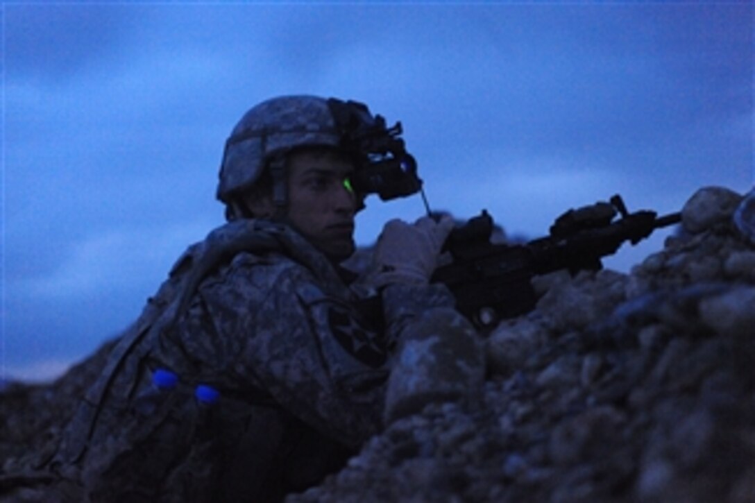 U.S. Army Pfc. Stevie Wise, with Charlie Company, 1st Battalion, 17th Infantry Regiment, 5th Brigade Combat Team, 2nd Infantry Division, searches for enemy movement using night vision goggles during a security mission in Chabar, Afghanistan, on Dec. 3, 2009.  Wise is conducting counterinsurgency operations in support of Operation Enduring Freedom.  