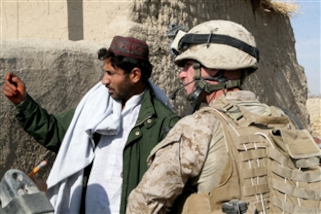 U.S. Marine Corps Sgt. Stephen G. Patten talks to a villager during a patrol through the fields and town of Amir Agha in Garmsir, Afghanistan, Dec. 2, 2009. Patten is assigned to Company G, 2nd Battalion, 2nd Marine Regiment.