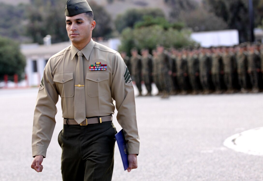 Sgt. Jose R. Lucero, scout sniper instructor and team member, School of Infantry West, Marine Corps Base Camp Pendleton, leaves the 52-Area parade deck after local government officials recognized him with a Congressional Recognition Award at Camp Pendleton, Dec. 8, for recent sniper competition victories.