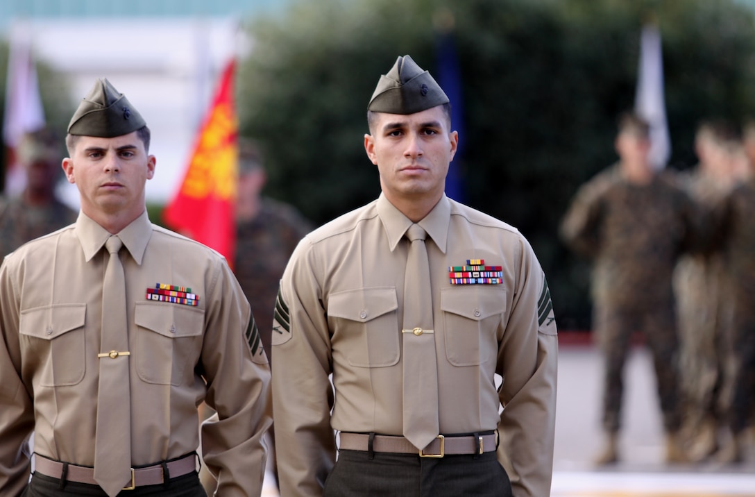 Sgt. Daniel S. Gilland (left) and Sgt. Jose R. Lucero, sniper instructors and teammates, School of Infantry West, Marine Corps Base Camp Pendleton, stand in formation during India Company’s Marine Corps Combat Training graduation of 291 Marines moments before local government officials recognized the instructors and two sniper teams with a Congressional Recognition Award at Camp Pendleton, Dec. 8, for recent sniper competition victories.