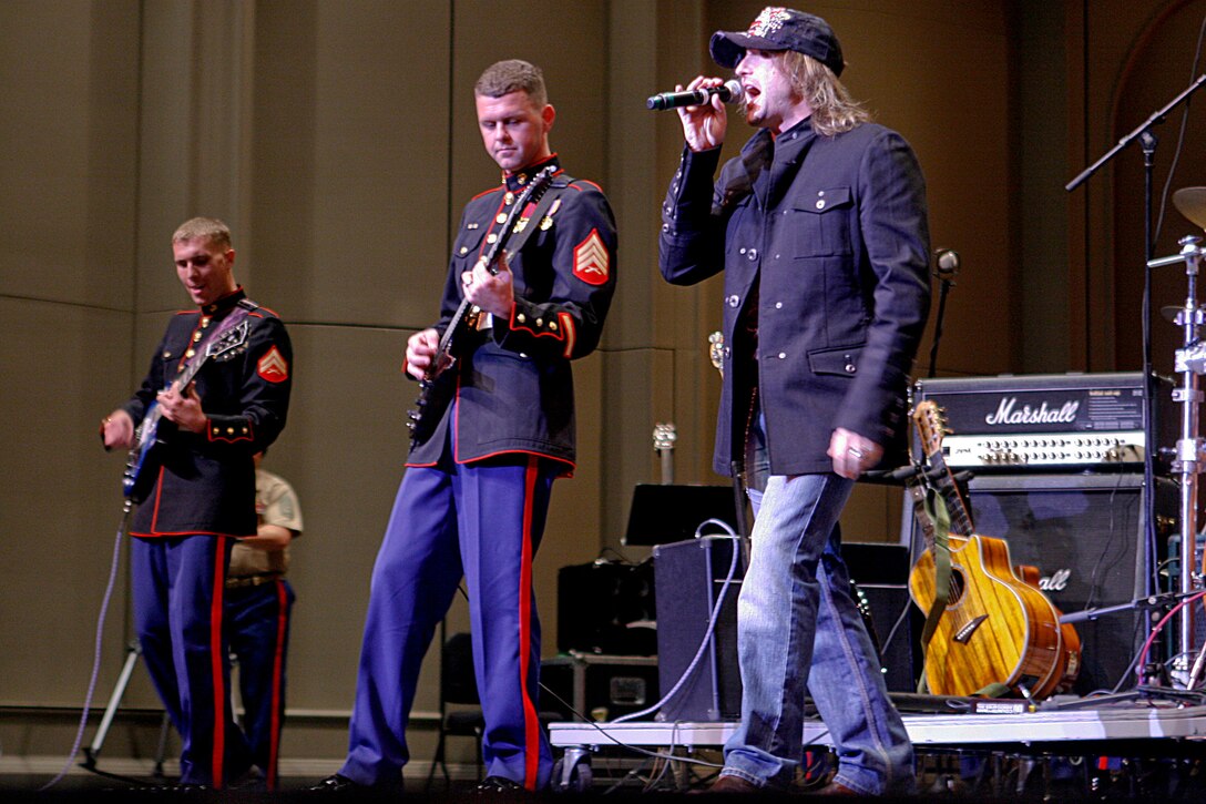 Local singer Steve Hott sings 'Rockin’ Around the Christmas Tree,' accompanied by the U.S. Marine Corps Forces, Pacific band during the Second Annual Na Mele o na Keiki, 'Music for the Children' Toys for Tots concert at the Neal S. Blaisdell Concert Hall Dec. 9. (Official U.S. Marine Corps photo by Sgt. Scott Whittington) (Released)::r::::n::