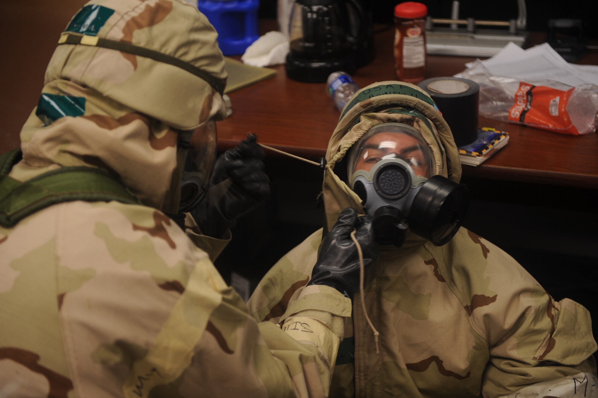 Airmen practice buddy checks to ensure their gas masks have been properly donned during the operational readiness exercise on Seymour Johnson Air Force Base, N.C., Dec. 9, 2009. Buddy checks are accomplished to ensure all straps and buttons have been fastened properly to avoid contamination. (U.S. Air Force photo/Senior Airman Ciara Wymbs) 