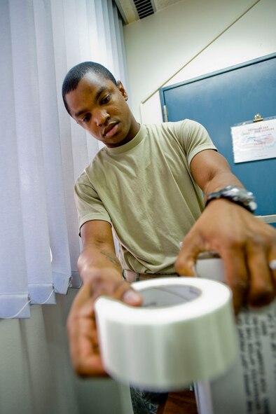MISAWA AIR BASE, Japan -- Senior Airman Keyone Cropper, 35th Communications Squadron official mail center clerk, secures a package Dec. 7 at the post office. During the holiday season, the post office can easily become one of the busiest units on base, especially with many residents sending packages to family and friends back in the U.S. (U.S. Air Force photo/Senior Airman Jamal D. Sutter)