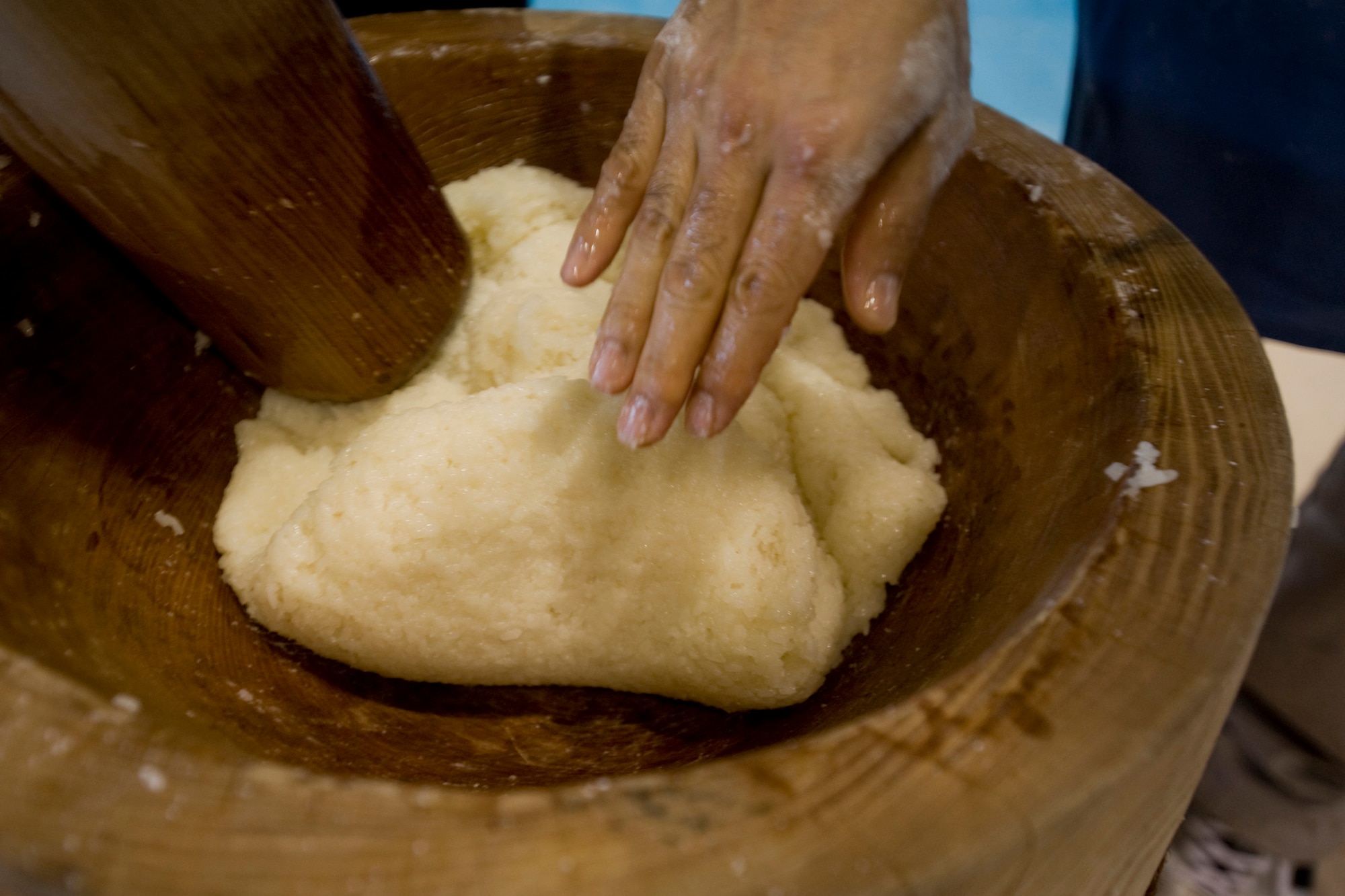 MISAWA AIR BASE, Japan -- The process of pounding rice requires team work and coordination amongst those who participate. The work is alternated with one person pounding the rice and the other turning the rice. Miscommunication may result in someone being injured by the wooden mallet. (U.S. Air Force photo/Senior Airman Jamal D. Sutter)