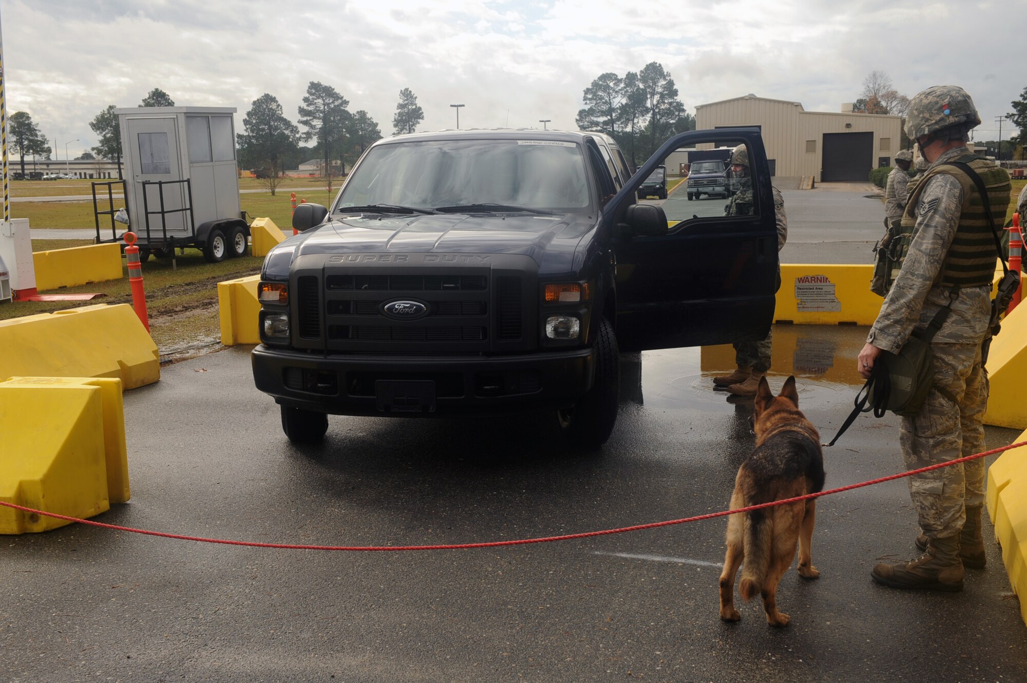 Security forces Airmen conduct a vehicle inspection at tent city on Base X during a Phase II operational readiness exercise , Dec. 9, 2009. A vehicle inspection is done on every vehicle entering the compound to ensure no harmful contraband items are brought on base. (U.S. Air Force photo/Senior Airman Ciara Wymbs) 