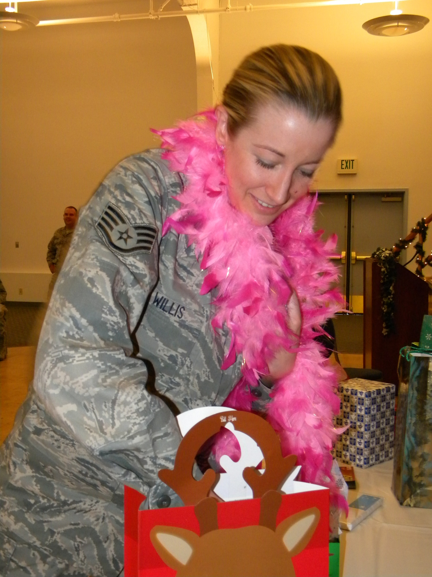 Staff Sgt. Stacia Willis dons part of her gift, then delves deeper into her bag for more goodies during the Santa gift exchange at the 50th Intelligence Squadron holiday party, Dec. 6.  Squadron members enjoyed a banquet at the Beale Community Activity Center and toasted the promotion of Master Sgt. Erreck Conley, 50th IS unit training manager. The 50th IS is part of the 940th Wing, Beale Air Force Base, Calif. (U.S. Air Force photo/Tech. Sgt. Kenneth McCann)