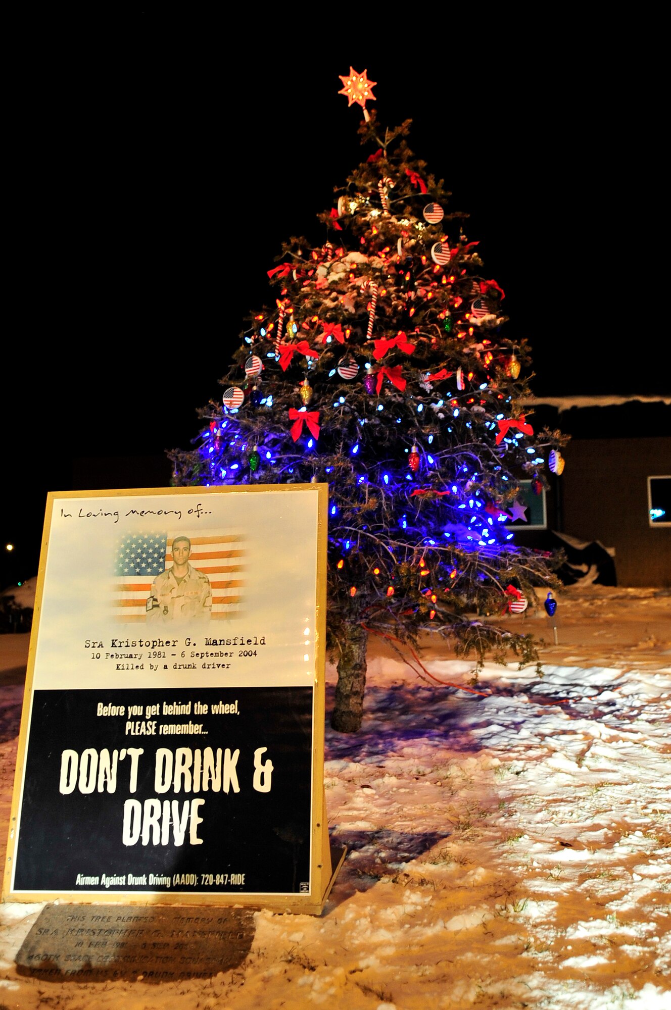 BUCKLEY AIR FORCE BASE, Colo. -- A tree is lit every year in front of the Buckley Fitness Center in honor of Senior Airman Kristopher G. Mansfield December 8. The ceremony takes place every year to honor Airman Mansfield, who was killed in a drunk driving accident in 2004.  (U.S. Air Force photo by Airman First Class Manisha Vasquez)