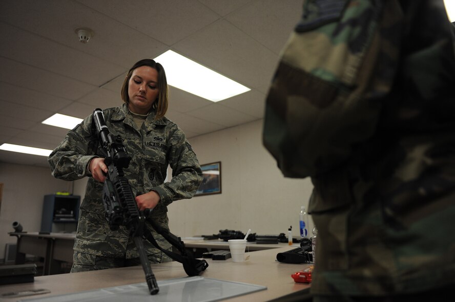 MINOT AIR FORCE BASE, N.D. -- Staff Sgt. Melissa Haggearty  5th Security Forces Squadron combat arms training and maintenance instructor, instructs a class on the M-4 Carbine here Dec. 9. Sergeant Haggearty’s commitment is to ensuring Minot’s Airmen are proficient with combat firearms. (U.S. Air Force photo by Staff Sgt. Stacy Moless)