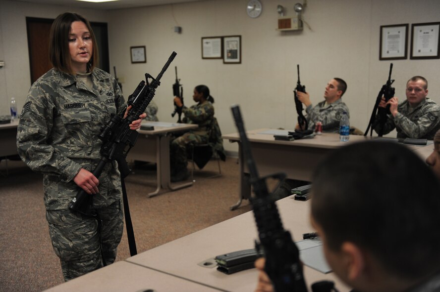 MINOT AIR FORCE BASE, N.D. -- Staff Sgt. Melissa Haggearty  5th Security Forces Squadron combat arms training and maintenance instructor, instructs a class on the M-4 Carbine here Dec. 9. Sergeant Haggearty’s commitment is to ensuring Minot’s Airmen are proficient with combat firearms. (U.S. Air Force photo by Staff Sgt. Stacy Moless)