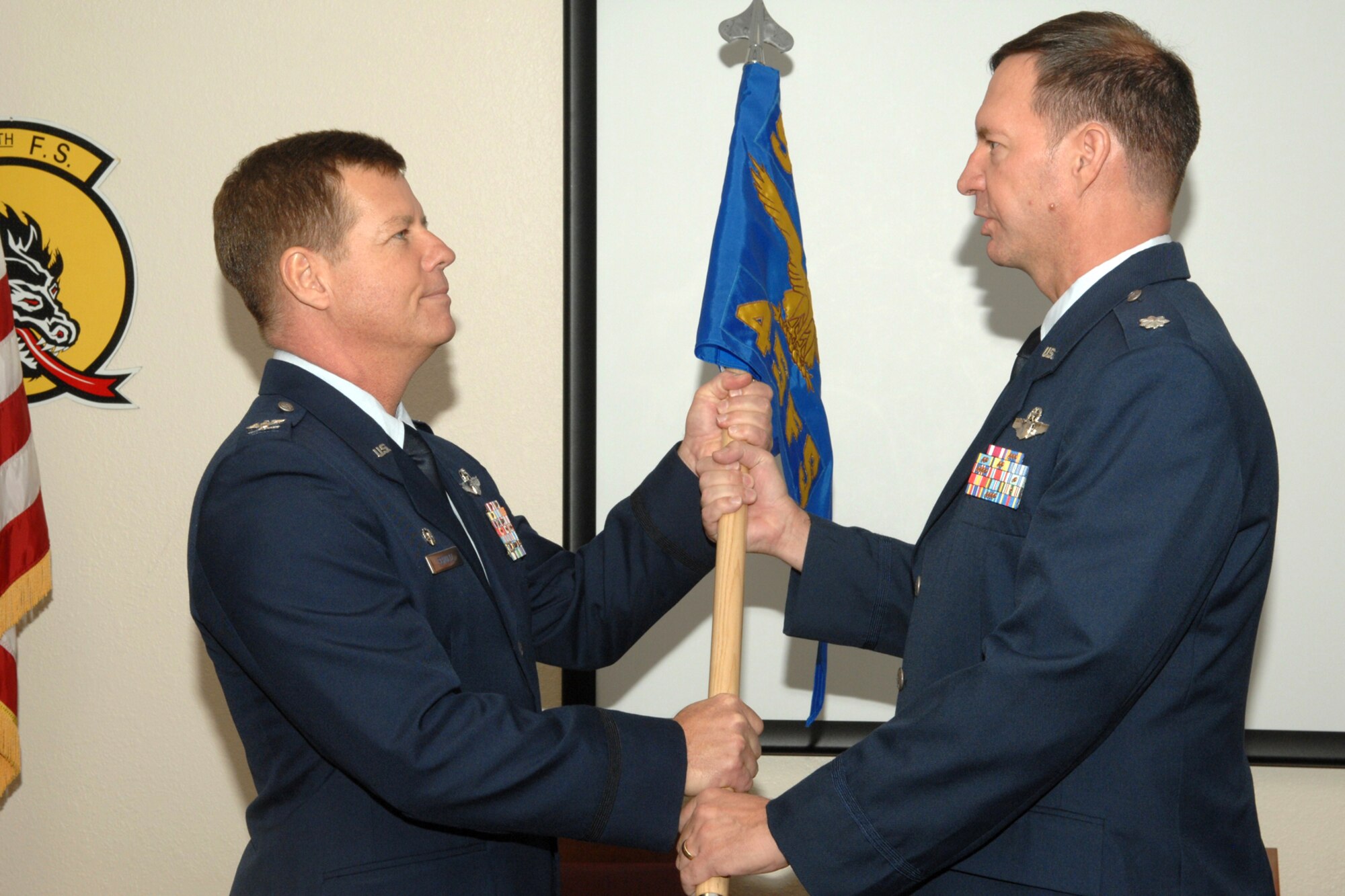 Lt. Col. Terry McClain accepts the 45th Fighter Squadron guidon from Colonel Keith Schultz, of the 917th Wing’s Operations Group at Barksdale Air Force Base, La., during the change of command ceremony for the 45th FS at Davis-Monthan Air Force Base, Ariz., December 5, 2009. In doing so, Colonel McClain took command of and responsibility for the 45th FS at Davis-Monthan. The 45th Fighter Squadron was originally activated Dec 1, 1940 as the 45th Pursuit (Fighter) Squadron, one of three squadrons assigned to the 15th Pursuit Group, Wheeler Field, territory of Hawaii. Inactivated and reactivated several times during its distinguished history, the 45th Fighter Squadron was once again reactivated November 1, 2009, as an associate unit with the 355th Fighter Wing at Davis-Monthan, assigned to the 917th Wing at Barksdale. (U.S. Air Force photo/Staff Sgt. Alicia Goosic)