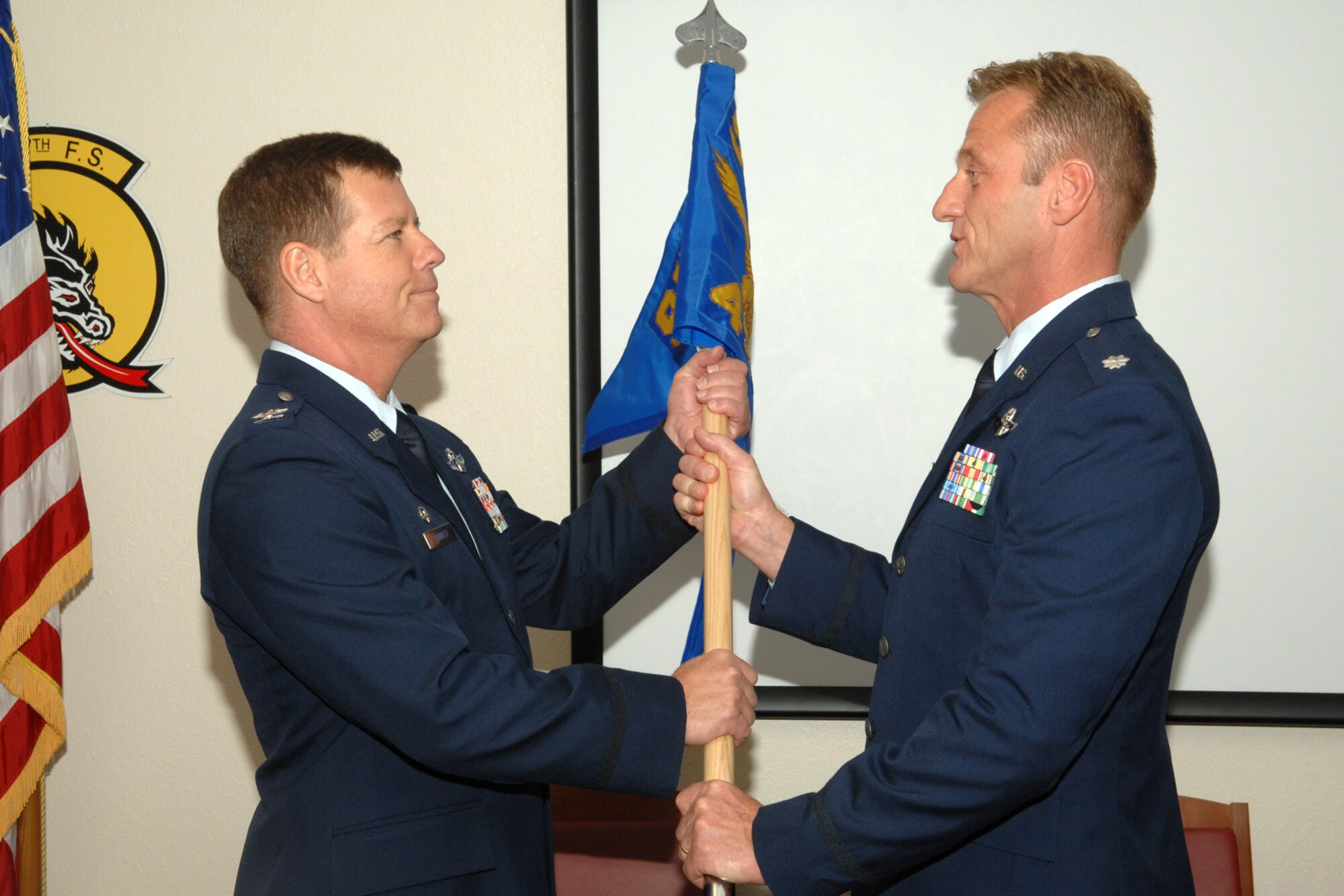 Colonel Keith Schultz, of the 917th Wing’s Operations Group at Barksdale Air Force Base, La., accepts the 45th Fighter Squadron guidon from Lt. Col. Rodney Glass, commander, 45th FS, during the change of command ceremony for the 45th FS at Davis-Monthan Air Force Base, Ariz., December 5, 2009. In doing so, Colonel Glass relinquished command of and responsibility for the 45th FS. The 45th Fighter Squadron was originally activated Dec 1, 1940 as the 45th Pursuit (Fighter) Squadron, one of three squadrons assigned to the 15th Pursuit Group, Wheeler Field, territory of Hawaii. Inactivated and reactivated several times during its distinguished history, the 45th Fighter Squadron was once again reactivated November 1, 2009, as an associate unit with the 355th Fighter Wing at Davis-Monthan, assigned to the 917th Wing at Barksdale. (U.S. Air Force photo/Staff Sgt. Alicia Goosic)