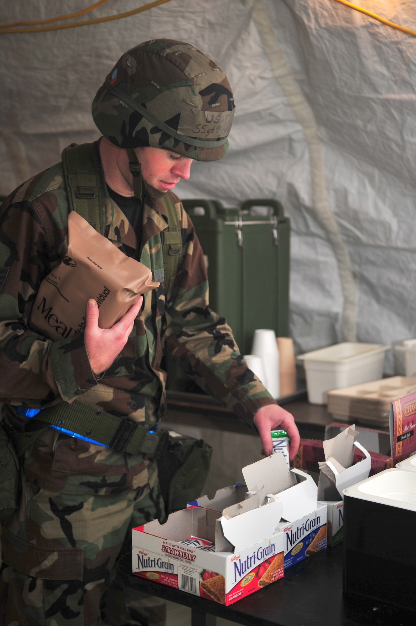 Staff Sgt. Richard Oates, 4th Force Support Squadron food service representative, gathers a Meal-Ready-to-Eat and supplemental snacks for lunch at tent city on Base X during an operational readiness exercise Phase II, Dec. 9, 2009.  The 4th FSS is provides food for Airmen participating in the exercise. (U.S. Air Force photo/Airman 1st Class Rae Perry)