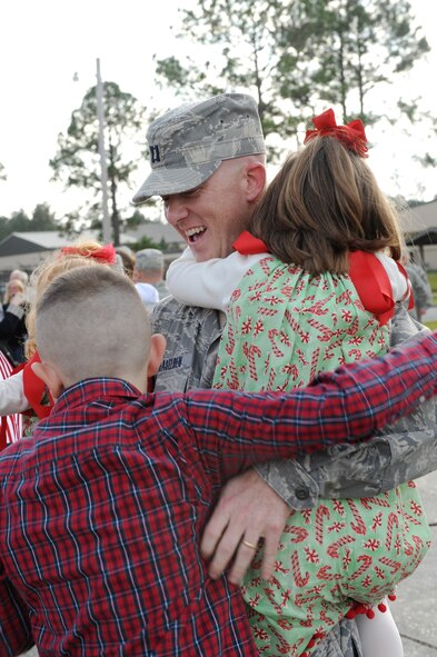 MOODY AIR FORCE BASE, Ga. – Capt. Scott Haselden, 822nd Security Forces Squadron member, gets a big hug from his children, Tyler, Aislinn, Reid, and Ainsley after returning home from a deployment to Camp Bucca, Iraq, here Dec. 8. The 822nd SFS was deployed to Camp Bucca, Iraq, and during the deployment, the squadron executed joint expeditionary taskings and performed outside-the-wire security operations and convoy escort. (U.S. Air Force photo by Airman 1st Class Benjamin Wiseman)