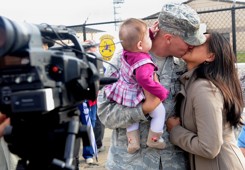 MOODY AIR FORCE BASE Ga. -- Airman 1st Class Timothy Canup, 822nd Security Forces Squadron member, is welcomed home by his wife Maricris and daughter Shaela here Dec. 8. During the deployment, Airman Canup’s daughter was born and this is the first time he met her. (U.S. Air Forces photo by Airman 1st Class Joshua Green)