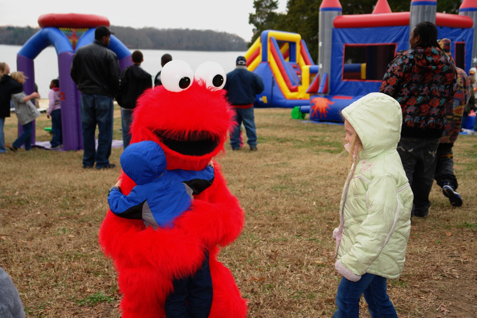 A little boy hugs Elmo, one of the many characters who greeted the children at the Children’s Christmas Party Dec. 6 at the Arnold Lakeside Center at Arnold Air Force Base. (Photo by Andrea Stephens)