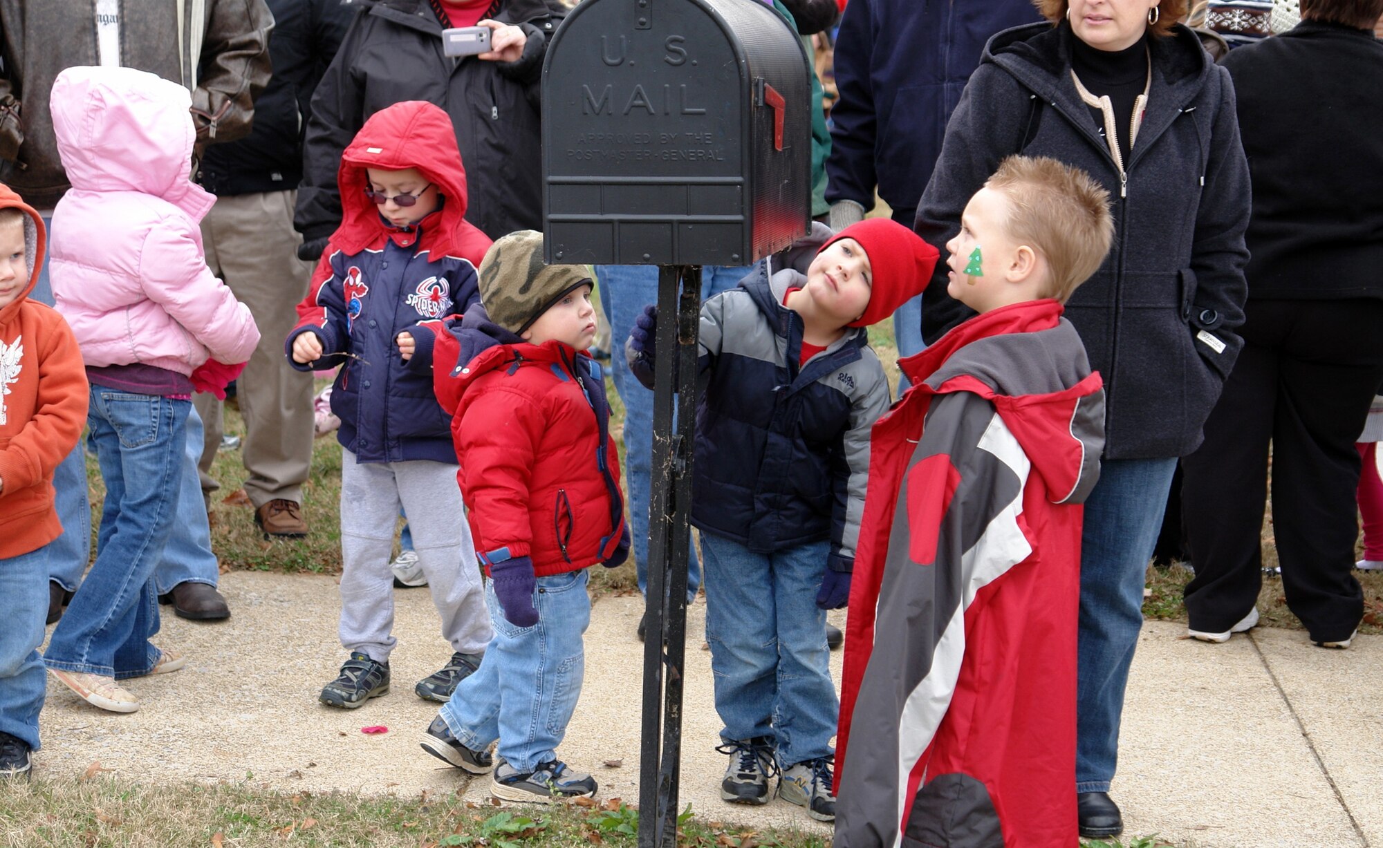 Three children gaze at what they think is Santa’s mailbox while they wait with the crowd for Santa’s arrival to the Children’s Christmas Party Dec. 6 at the Arnold Lakeside Center at Arnold Air Force Base. (Photo by Andrea Stephens)