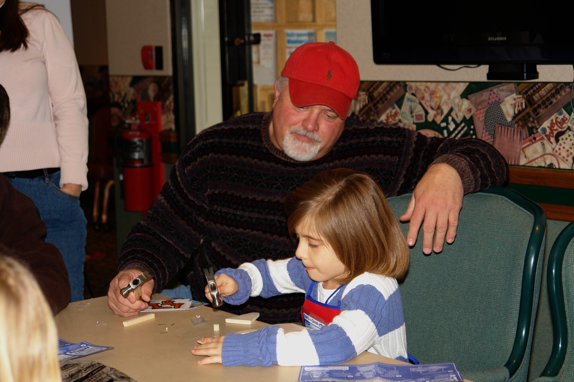 A father helps his daughter make a Christmas card at the Children’s Christmas Party Dec. 6 at the Arnold Lakeside Center at Arnold Air Force Base. (Photo by Andrea Stephens)