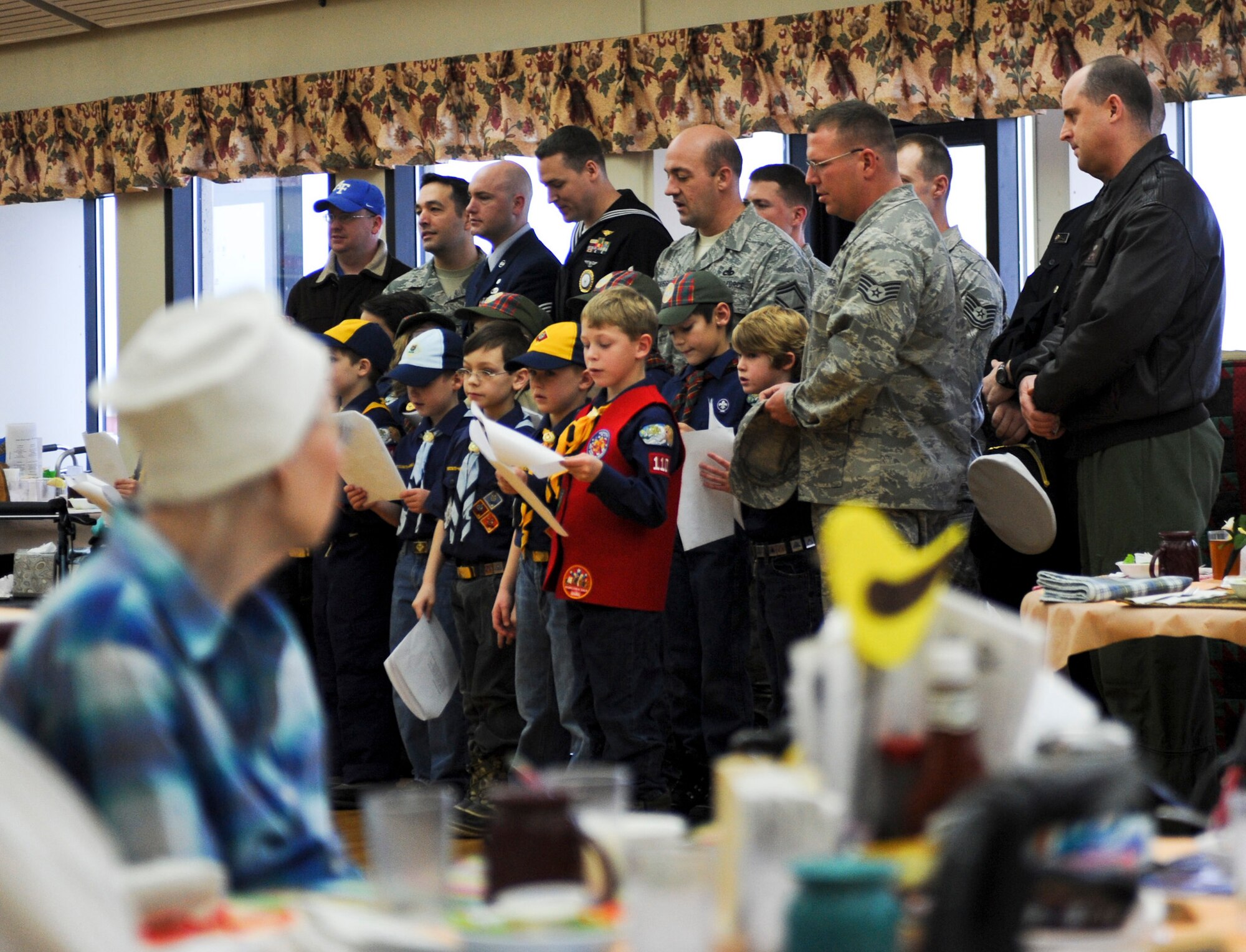 PIONEER VETERANS HOME, Alaska – Cub Scout Pack 110 and their parents sings Christmas carols to the residents of Pioneer Veterans Home, Dec. 5, for a community service project. Many of the scout’s parents serve in the military at Elmendorf Air Force Base or Fort Richardson. (U.S. Air Force photo/Airman 1st Class Christopher Gross)